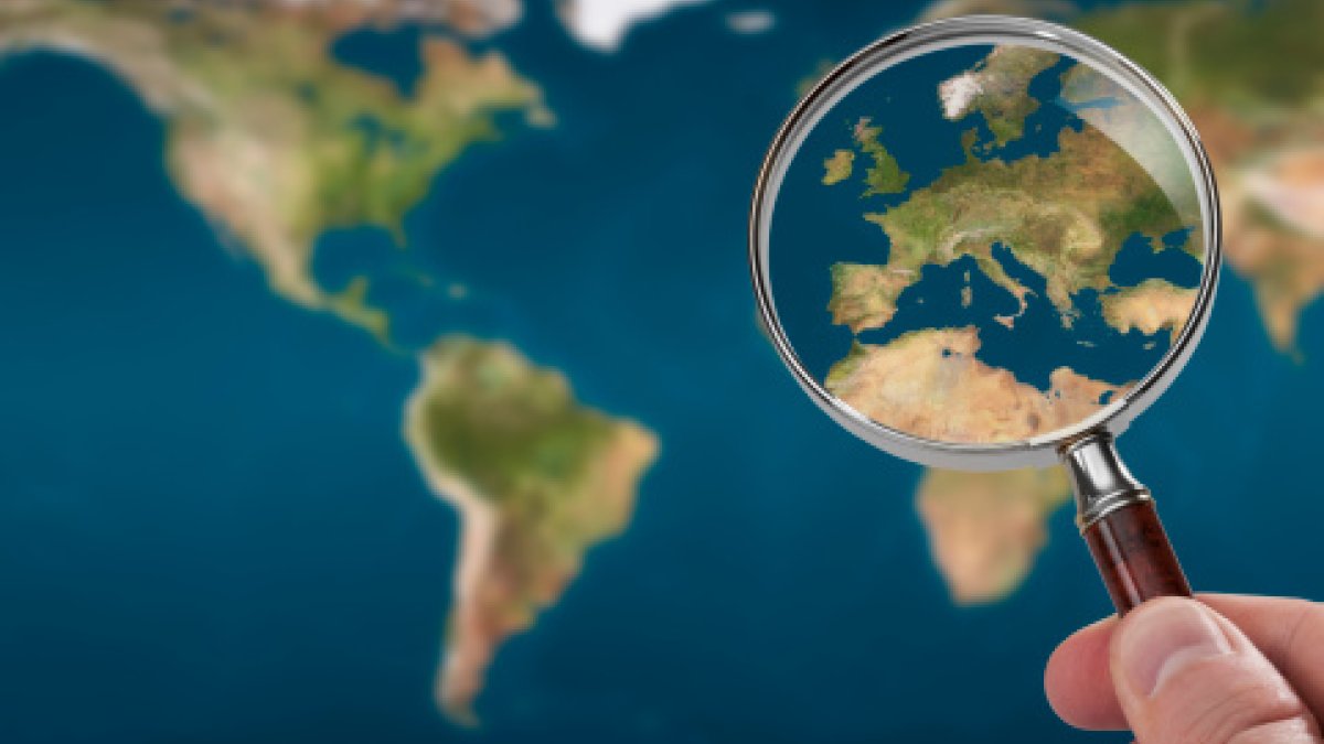 Magnifying glass over European map 