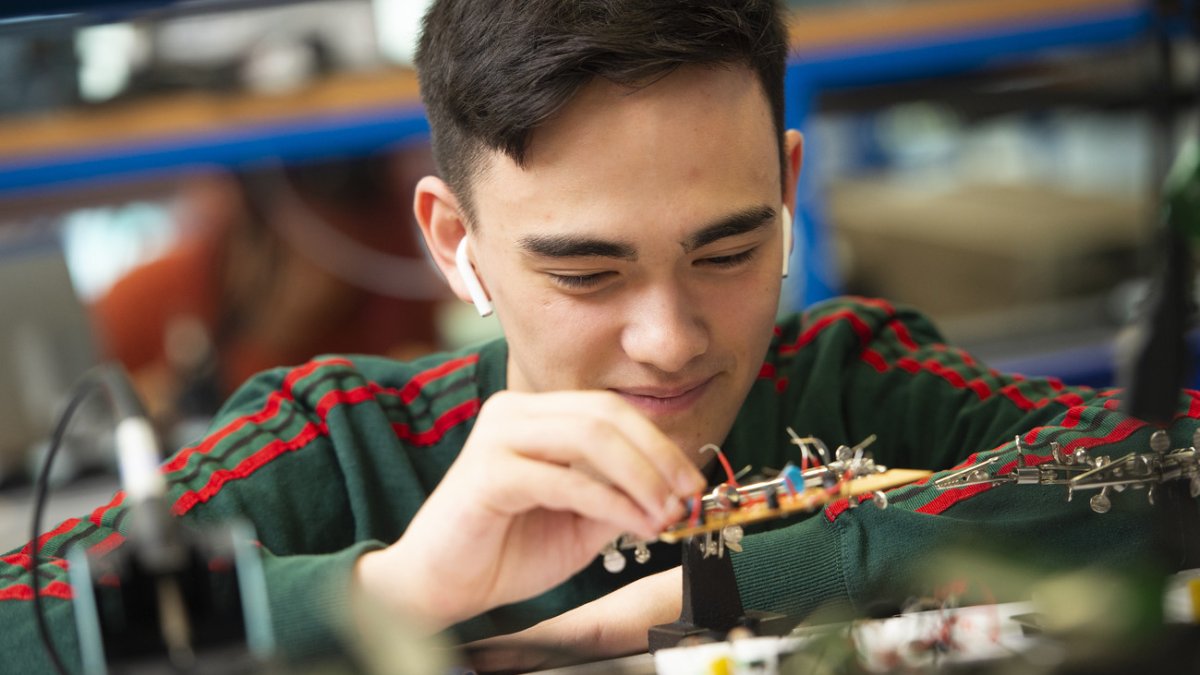Student in a circuit board workshop