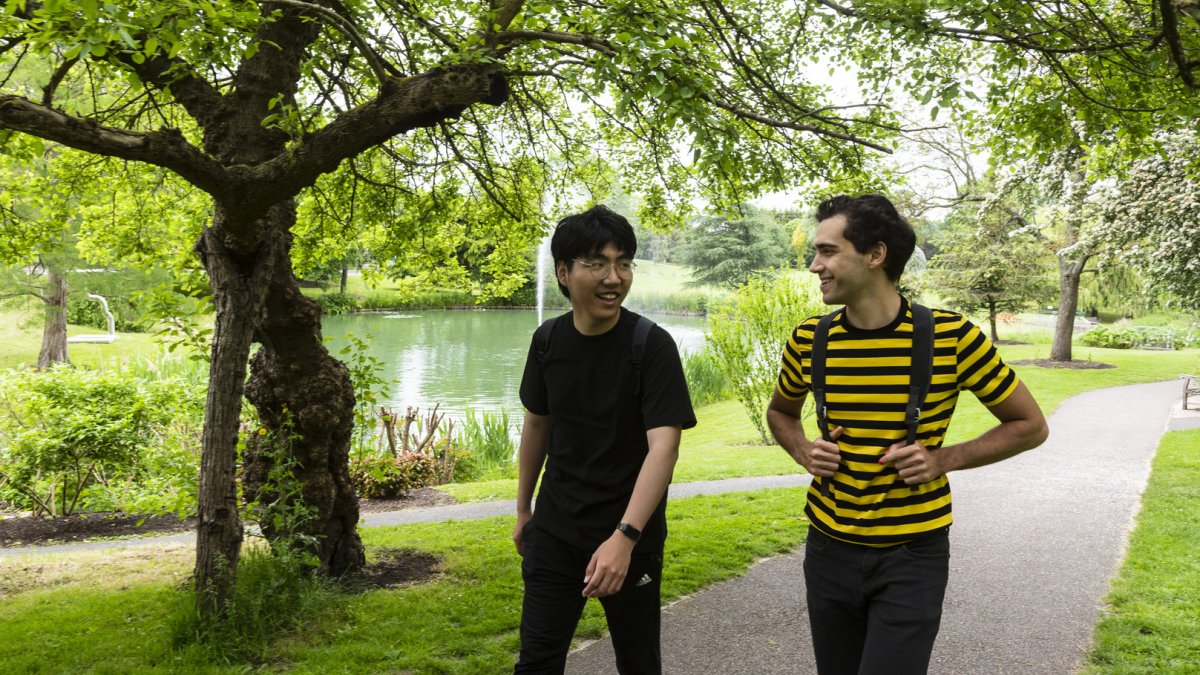 Students walking by the lake on campus