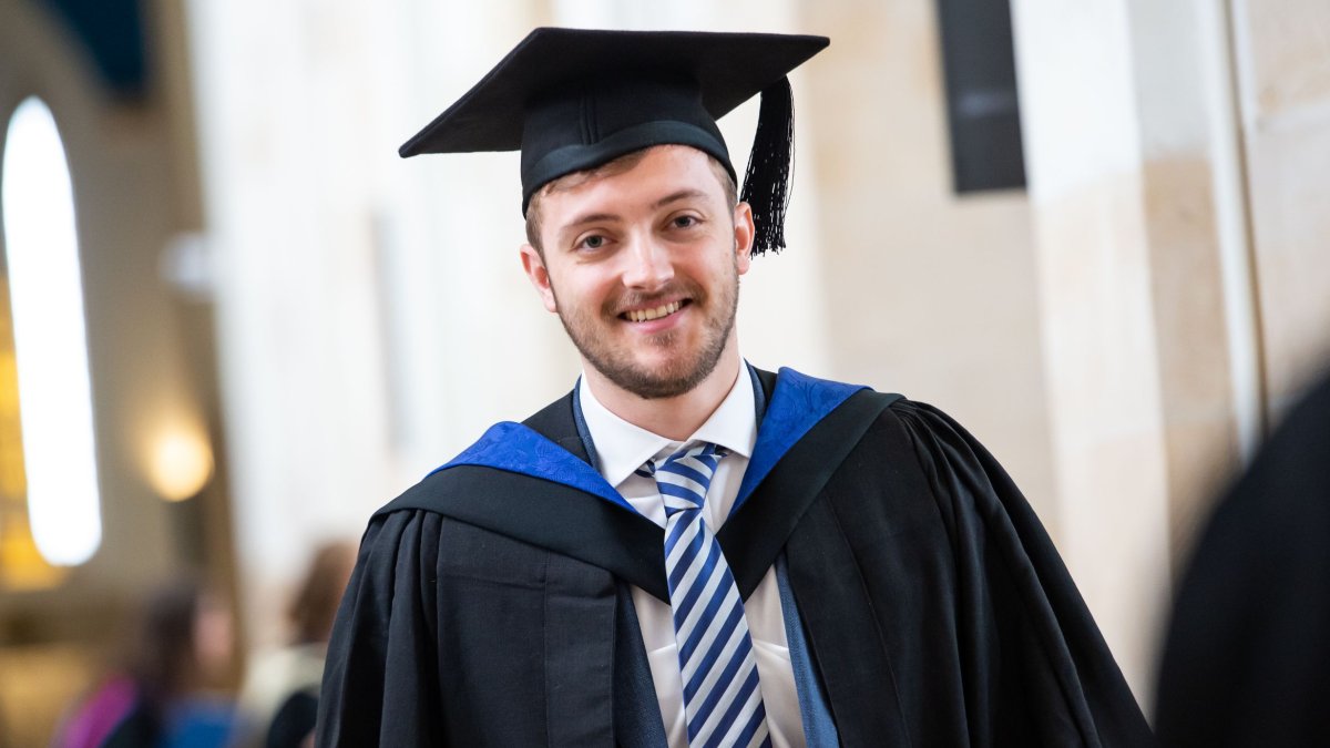 A graduand walking through Guildford Cathedral