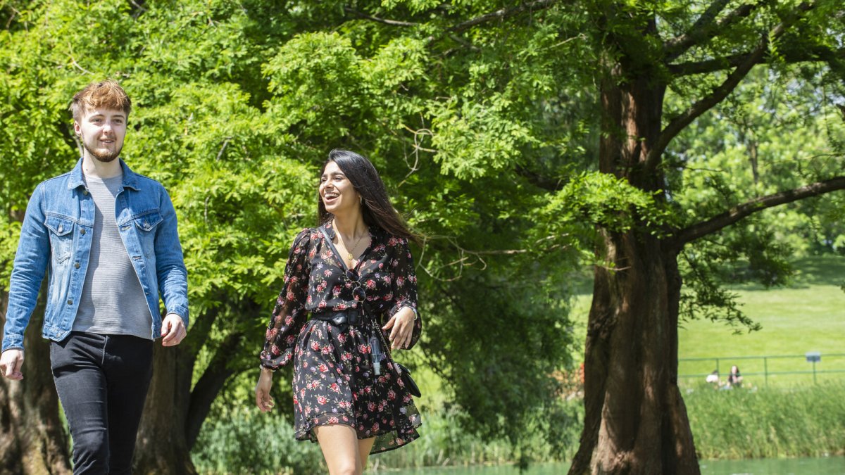 Students walking by the lake on campus