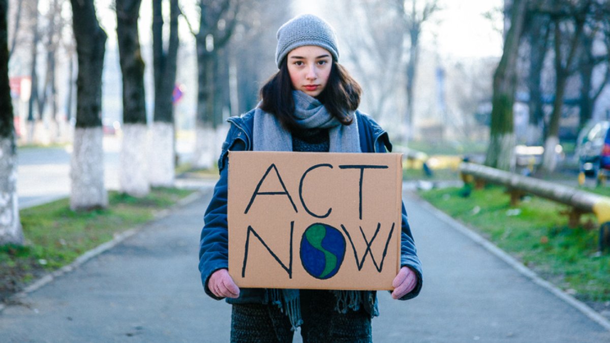 Young girl holding sign on climate change