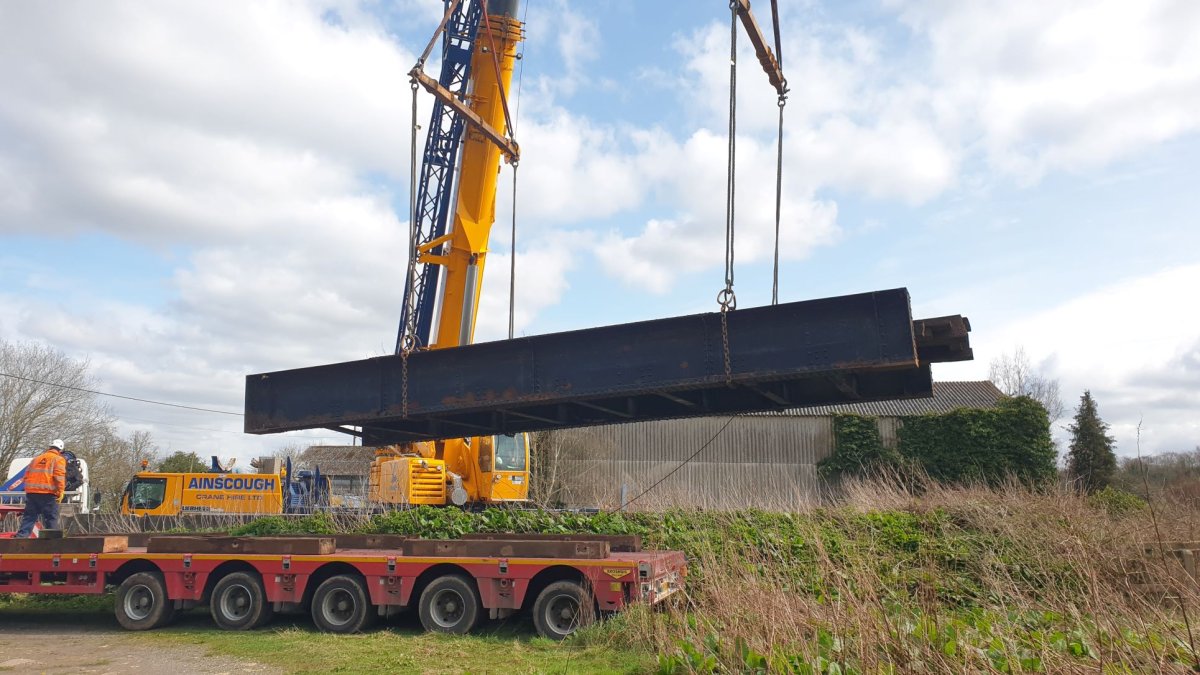 Section of railway bridge being craned onto lorry