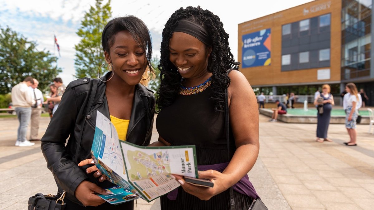 students looking at open day map outside campus buildings