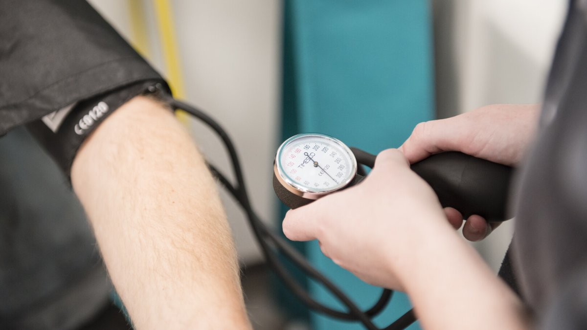 Student nurse taking blood pressure