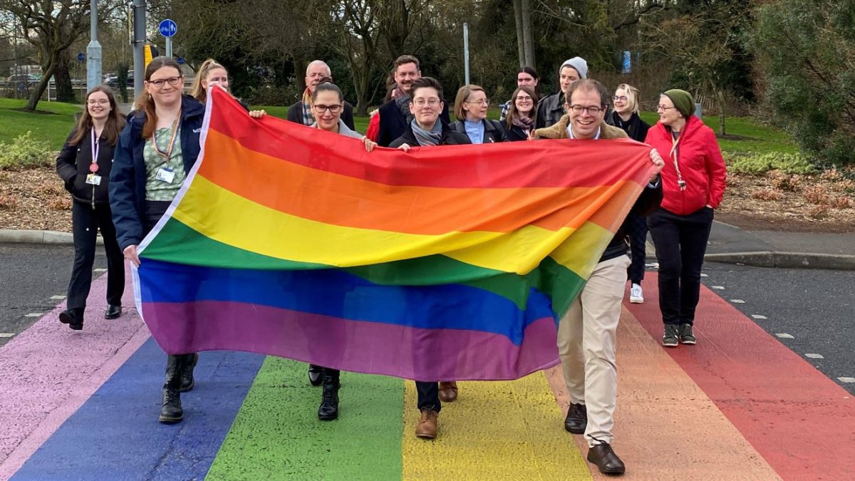 Surrey community on campus with rainbow flag