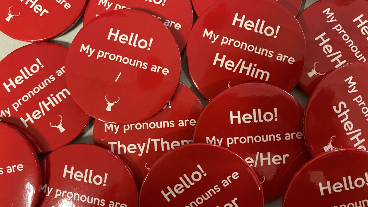 Pronoun badges in red
