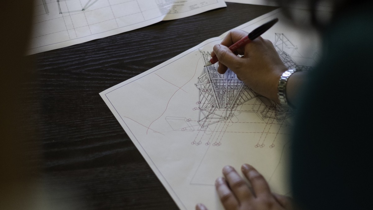 Female civil engineer draws roller coaster design