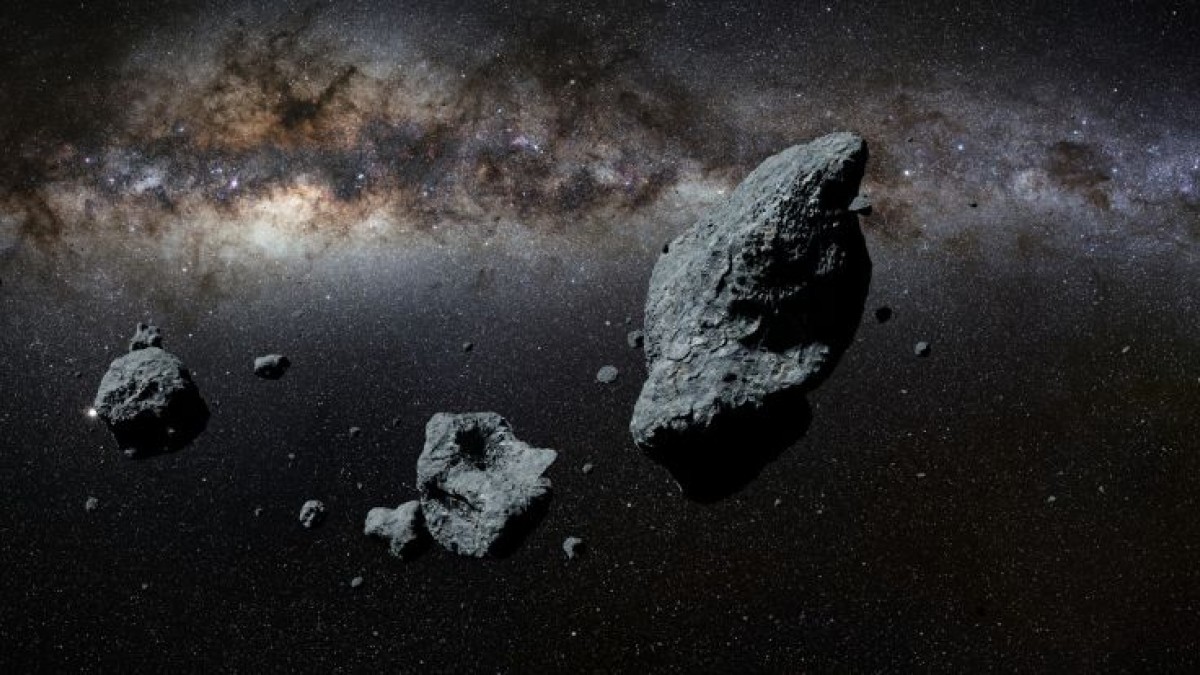 Asteroids in space with the Milky Way visible behind them