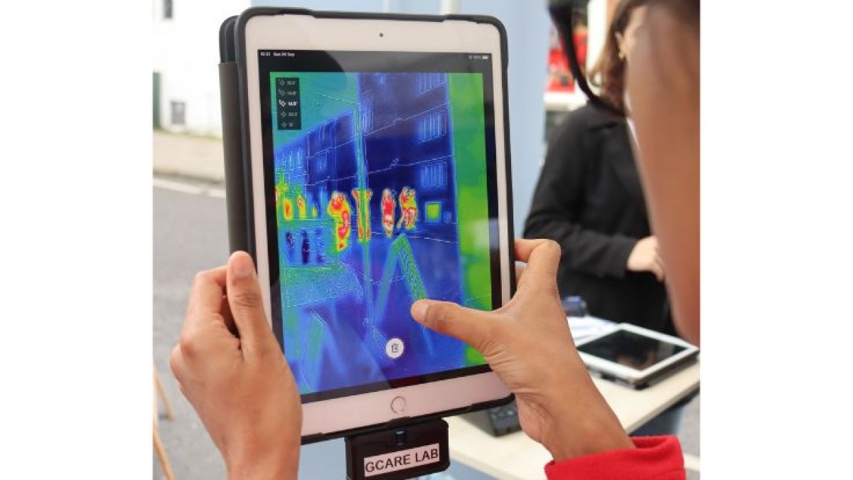 A tablet screen shows hot and cold areas in different colours