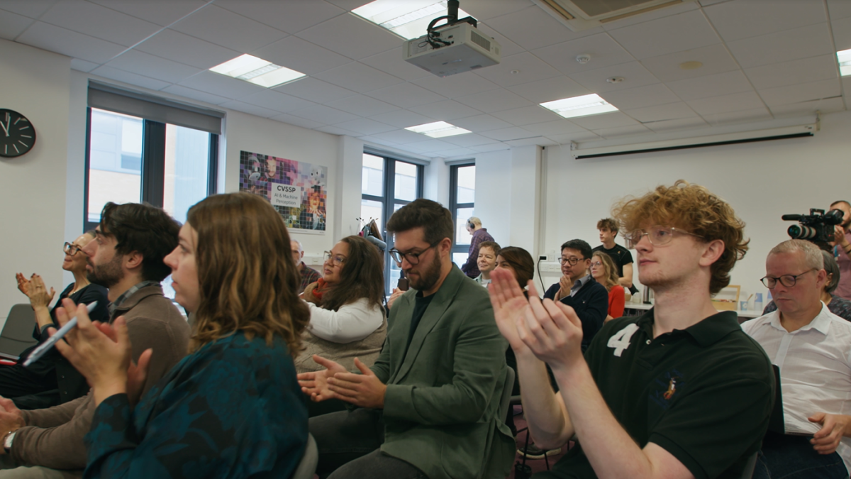 CDT researchers clapping in seminar room