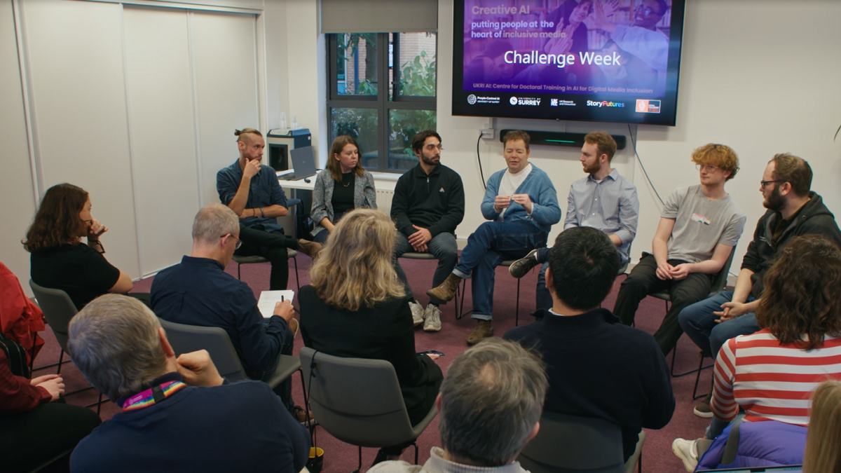 CDT researchers sitting in seminar room, looking at screen