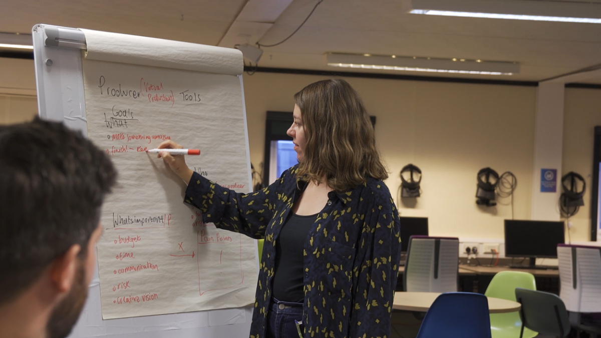 CDT researcher writing on flip chart