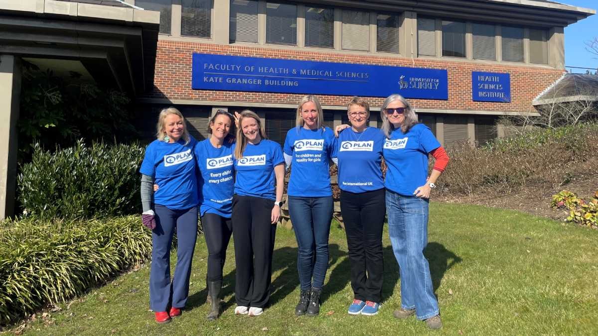 The step up for girls team standing in front of the Kate Granger Building