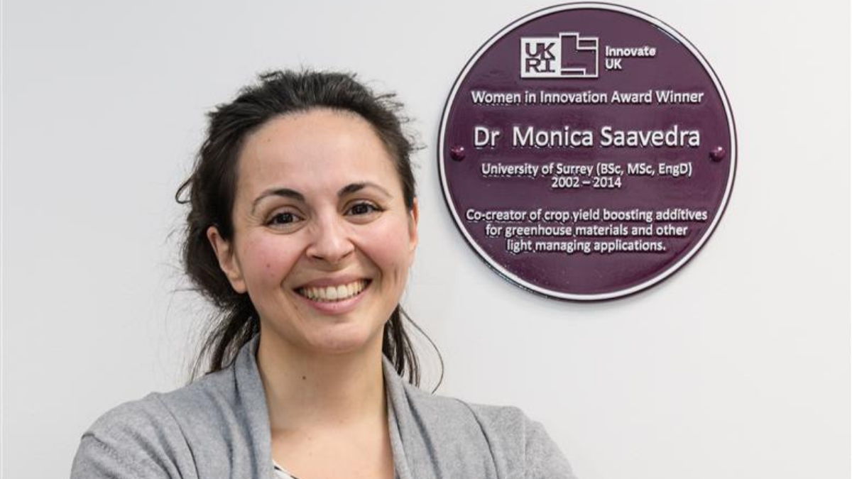 A photograph of Monica Saavedra with her purple plaque