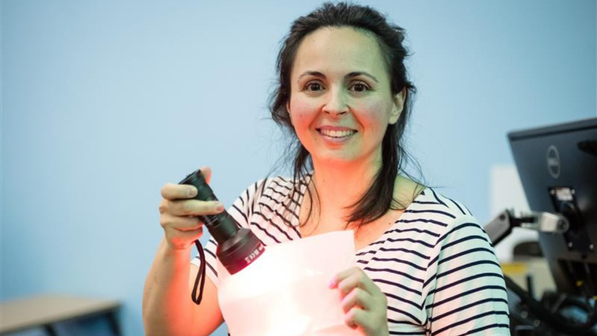 A photo of Monica demonstrating Lambda’s retrofittable active spray coating technology