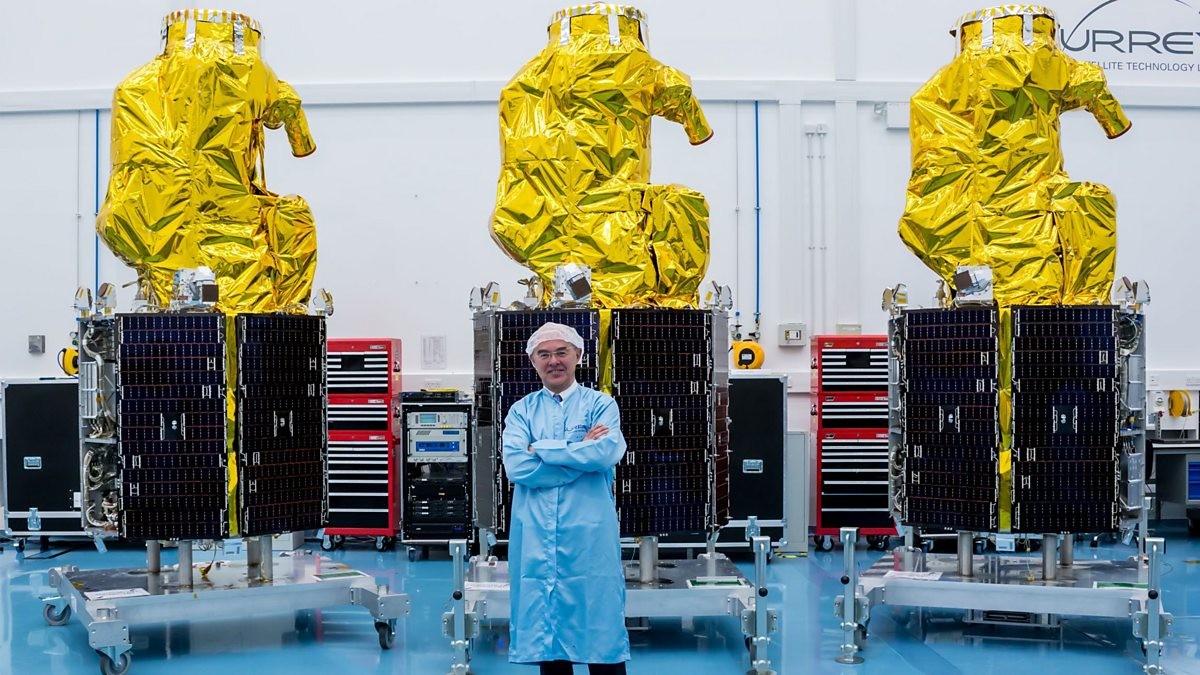 Professor Sir Martin Sweeting with satellites at Surrey Satellite Technology Ltd
