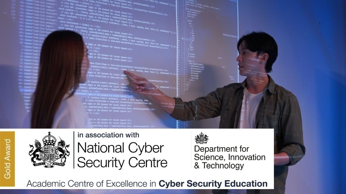 Developers give presentation in front of board with computer code