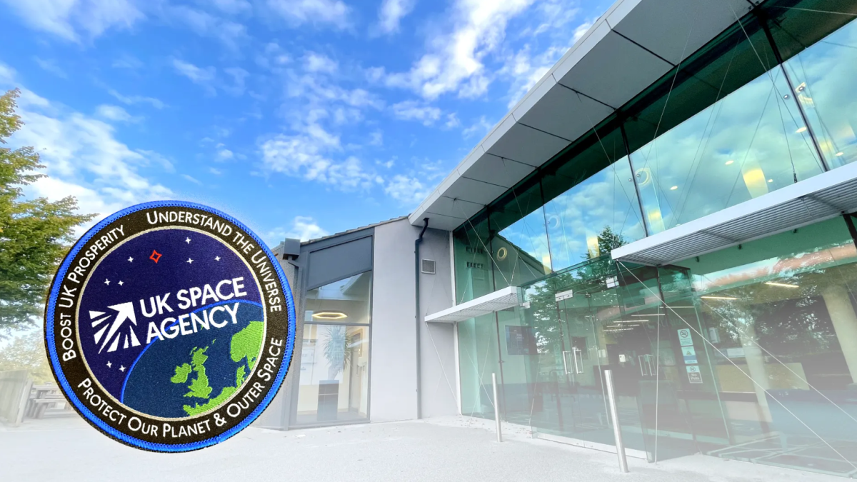 A mostly glass building with a stamp of the UK Space Agency