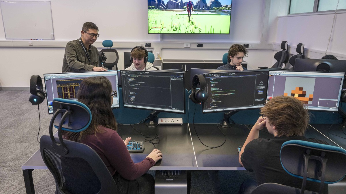 University of Surrey students looking at computer screens in a games laboratory