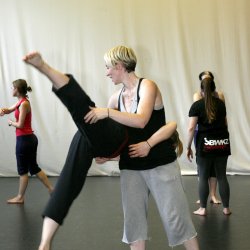 Woman holding dancing upside down.