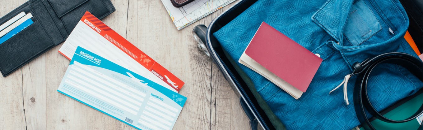 Boarding pass on table with suitcase