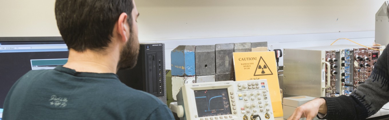 Student and teacher in physics lab