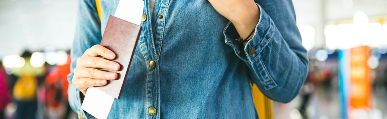 Person carrying passport at the airport